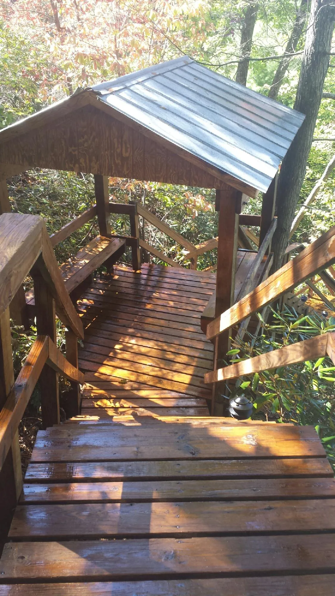 Freshly stained wood walkway and covered shelter with a metal roof in Milton Mills